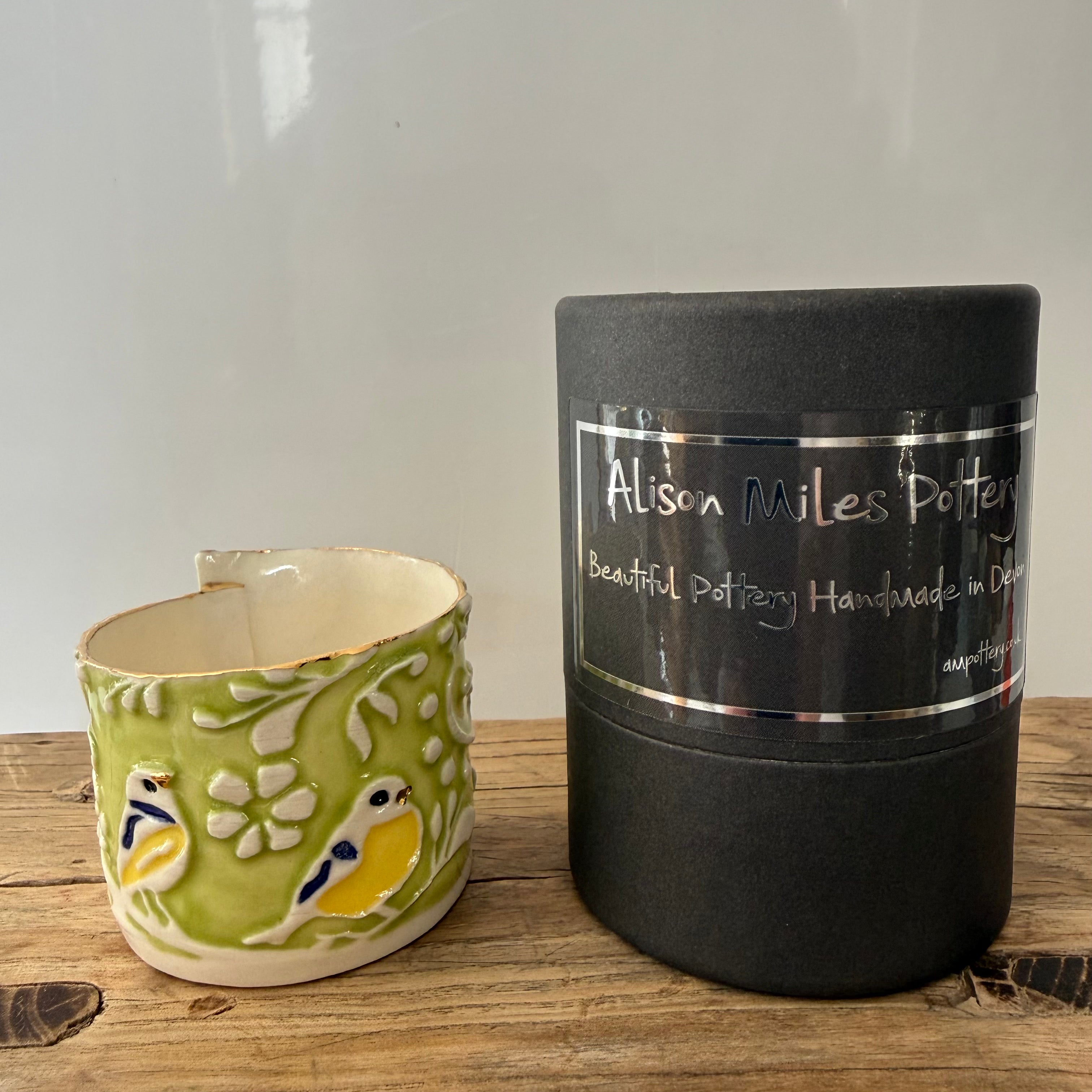 Porcelain tea-light holder, blue tits, pea-green with cobalt, naples and gold detail