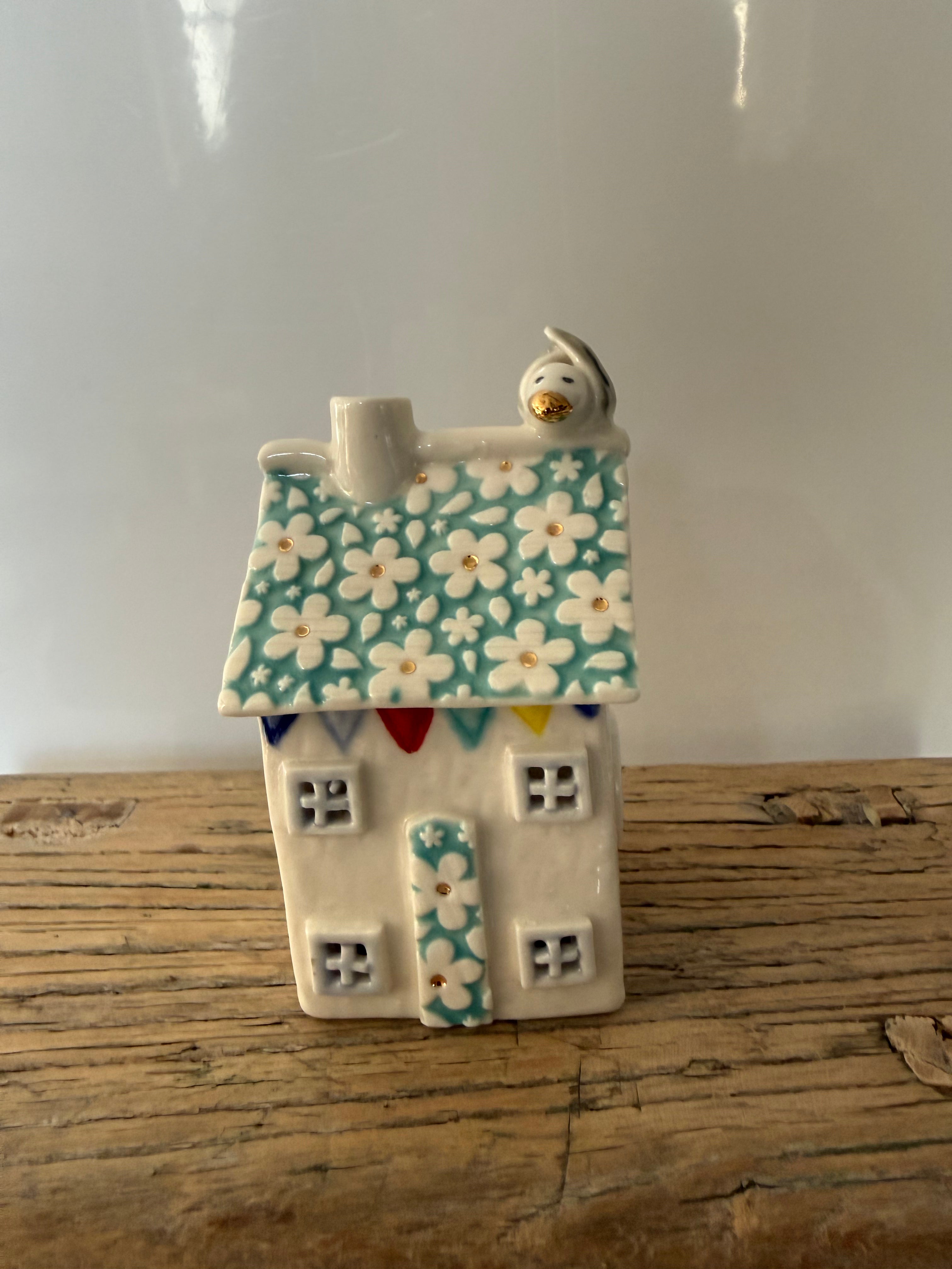 Small porcelain tea-light house, daisies, turquoise with gold detail