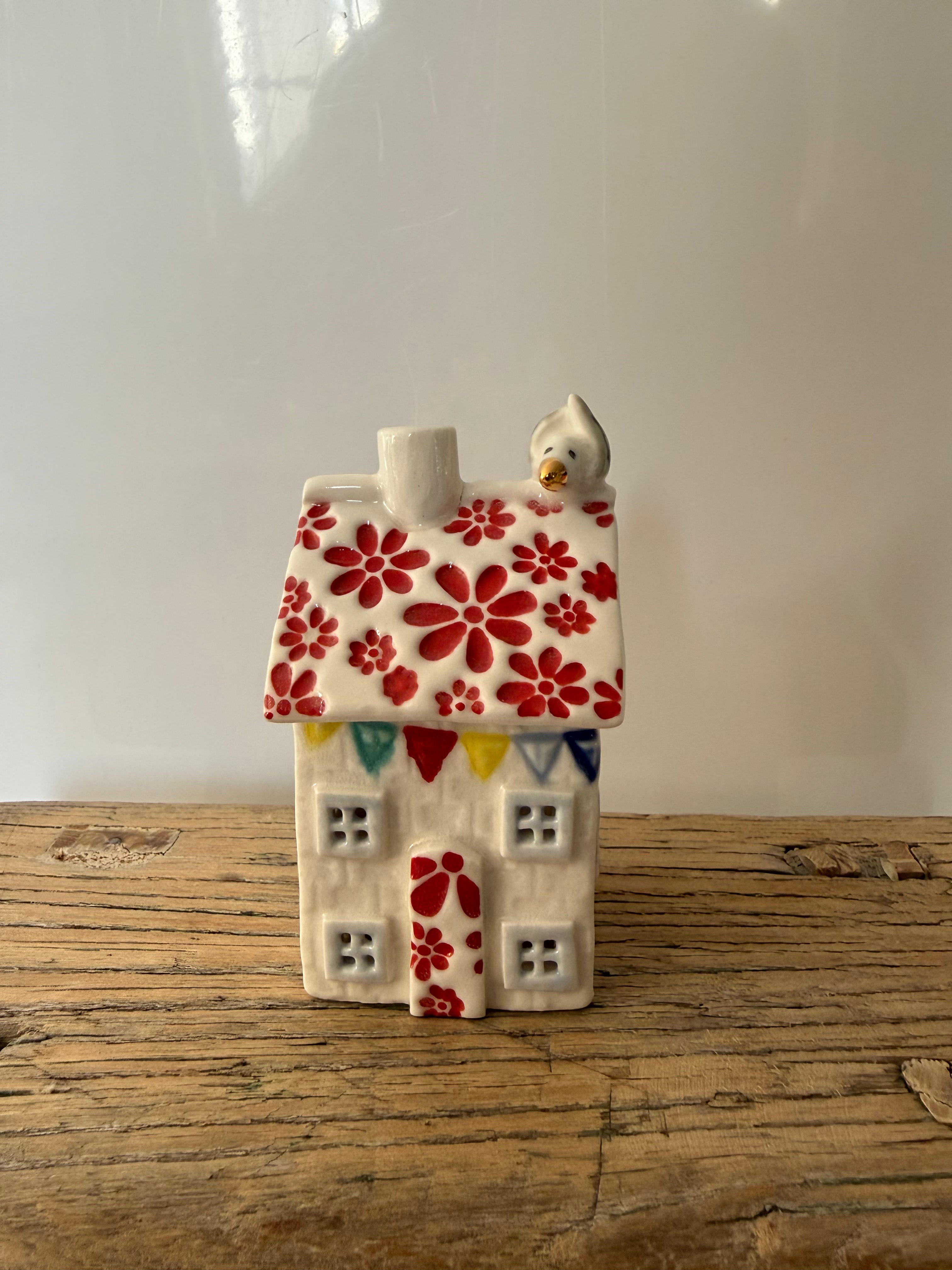 Small porcelain tea-light house, daisies 1, cherry red with gold detail